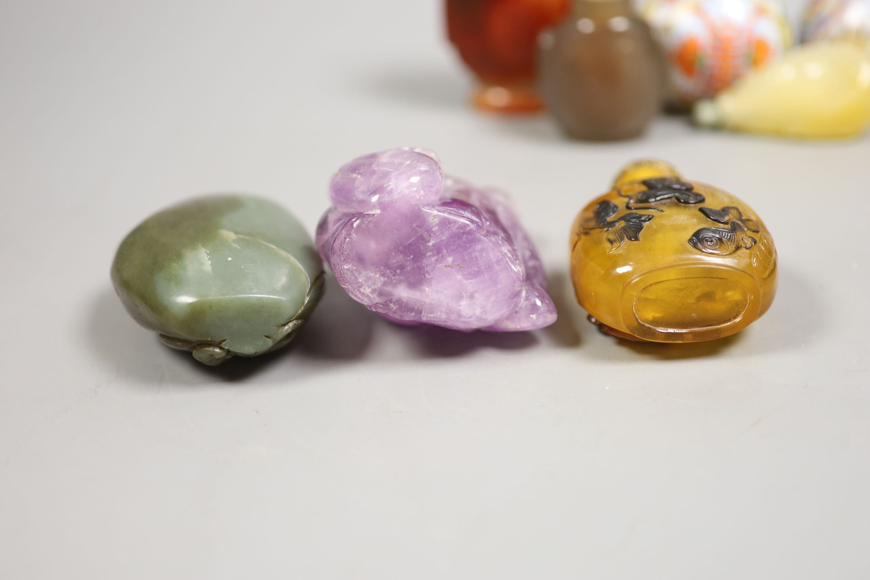 A group of Chinese jade, hardstone and glass snuff bottles, tallest 9.5 cm